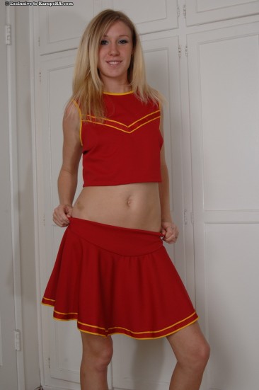 Blonde Allison Pierce in red cheerleader uniform and white panties toys her pussy