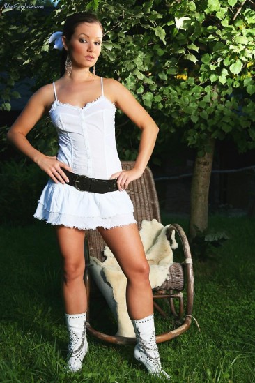 Brunette Jana Mrazkova strips her garments in the garden and masturbates wearing only leather belt.