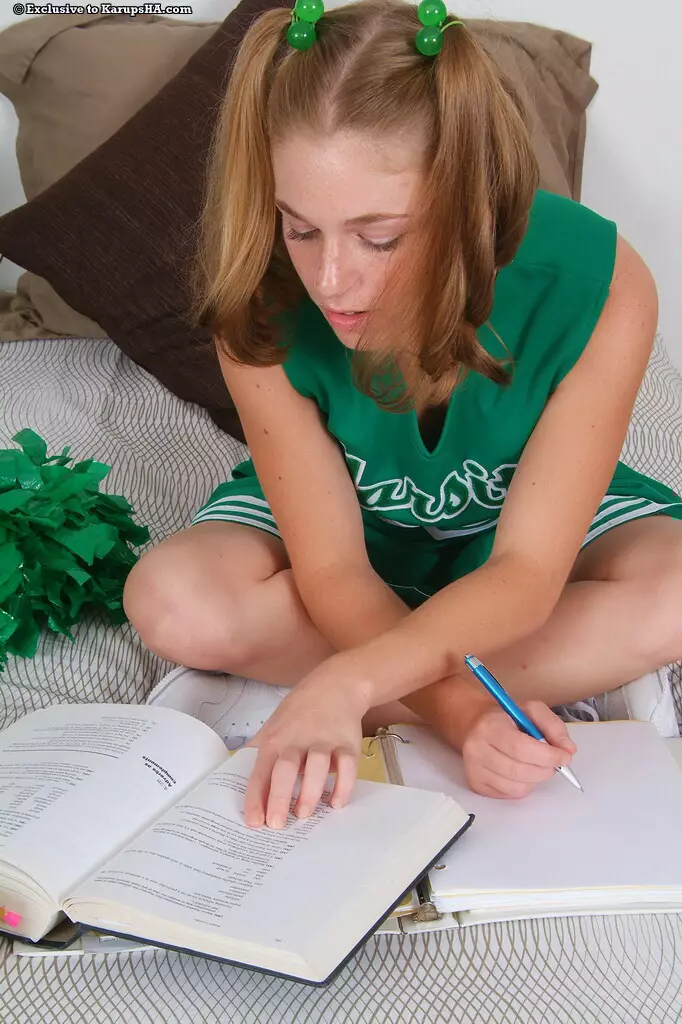 Pigtailed kitty Daisy Mae with pink pussy strips out of her green cheerleader uniform