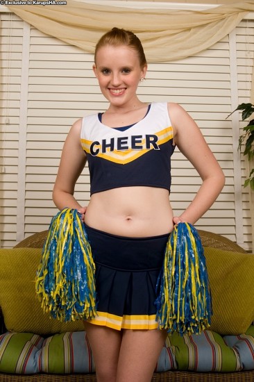 Petite smiling cheerleader Katey Grind gets totally nude and displays her shaved pink pussy