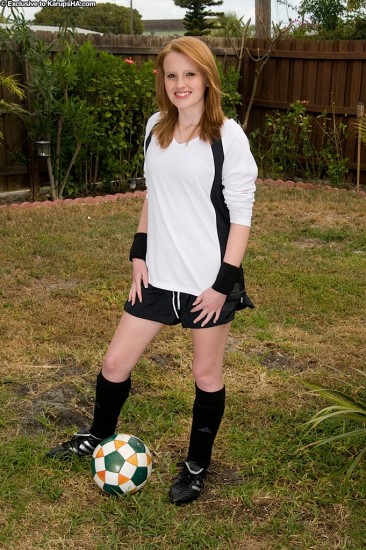 Red-haired soccer girl Katey Grind strips in the field and gives a close-up of her shaved snatch