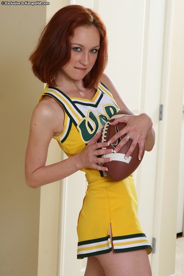 Petite shaved cheerleader Kyra Steele removes her yellow uniform and white panties