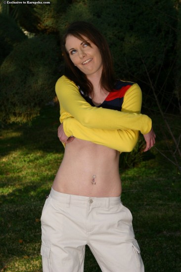 Lovely teen Tracy Odell displays her small tits and hairless snatch in the open air