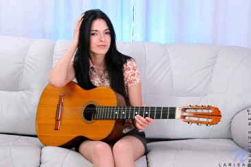 Sweet brunette in socks Larisa Nubiles plays the guitar and toys her juicy pussy