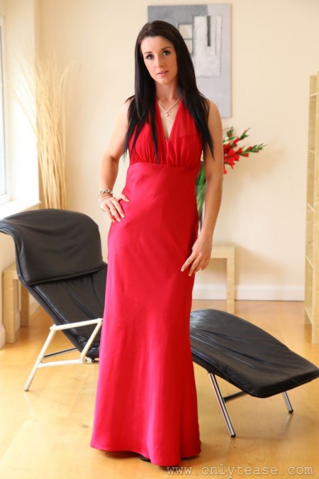 Elegant Sarah B in black stockings pulls off her long red dress and displays her boobs