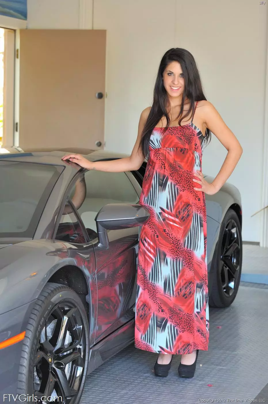 Teen brunette Lilly FTV in long dress flashes her tits and pussy as she poses by a car