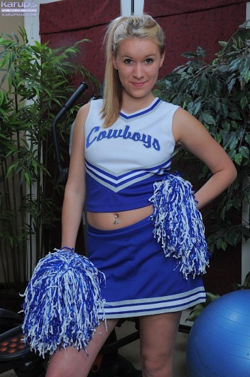 Cheerleader Kristi Kay takes off her blue uniform and displays her smooth pink pussy