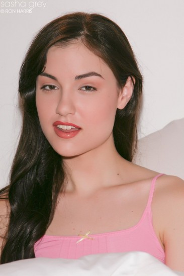 Lewd brunette in pink lingerie Sasha Grey naughtily shows tits and flashes pussy