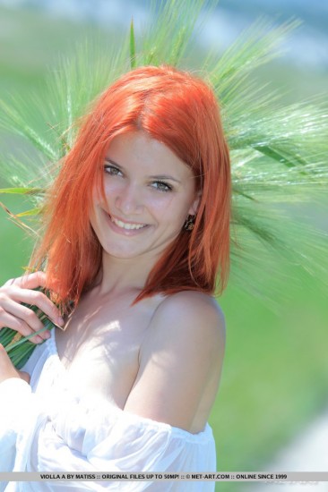 The redhead doll Violla A is in the green field letting the sun pet her peachy like beaver