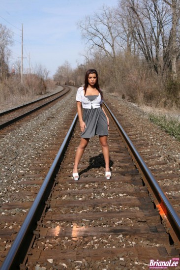 Sweet latino girl Briana Lee is posing in her sexy dress on railroad tracks and teases