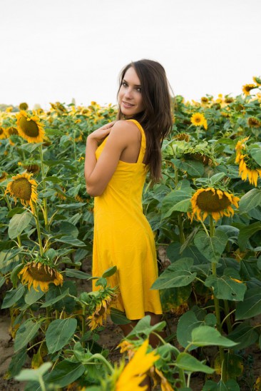 Gorgeous babe Semmi A removes her yellow dress outside in the sunflowers