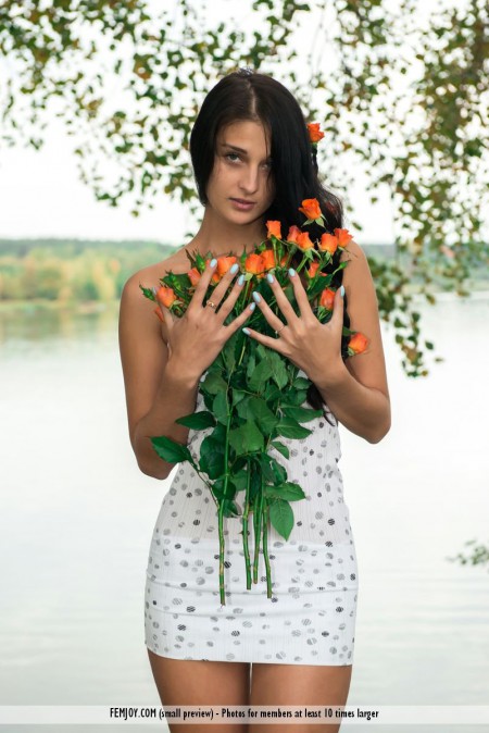 Naughty brunette chick Katya AC is posing with the nude bottom and bouquet of flowers