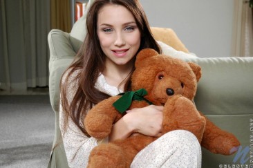 Young chick Celeste Nubiles has an innocent look when posing naked with bear