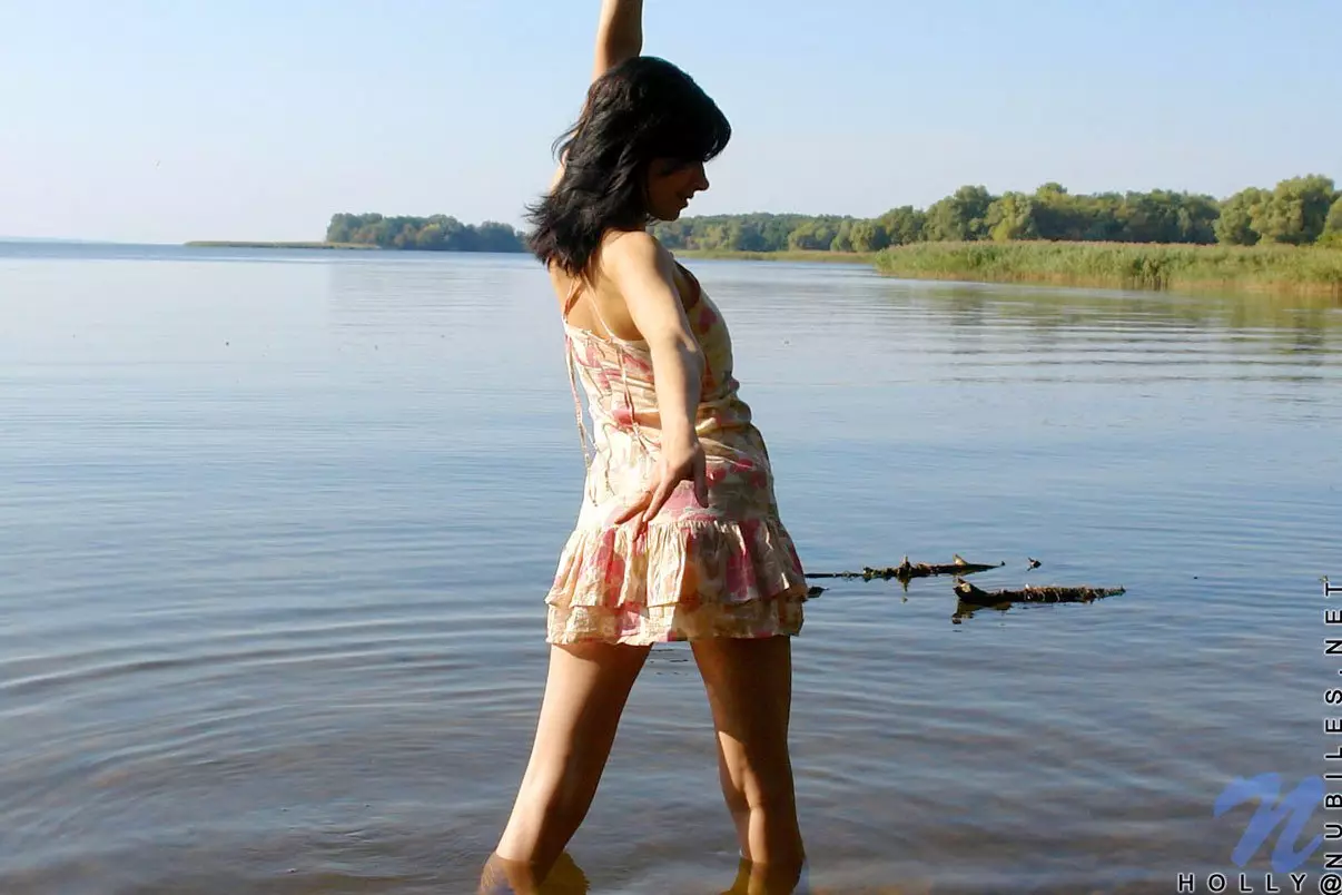 Dishy brunette teen Holly Nubiles in short dress goes in the river and strips playing.