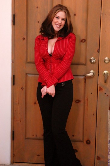 Frisky bimbo Lexy strips her red blouse and black pants showing big melons and trimmed pussy.
