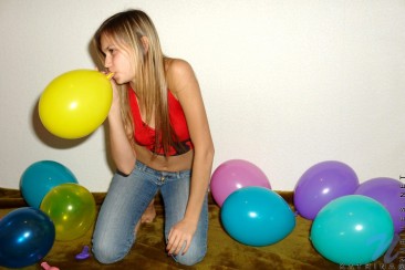 With her long blonde hair Katrina Nubiles blows up balloons and shows her teen side with cuteness.