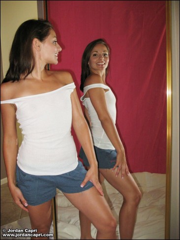Tight bodied sweetheart Jordan Capri drawing her clothes off in the mirror.