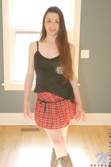 Shedding her school girl uniform Petra Nubiles exhibits her lean and tight body with long hair