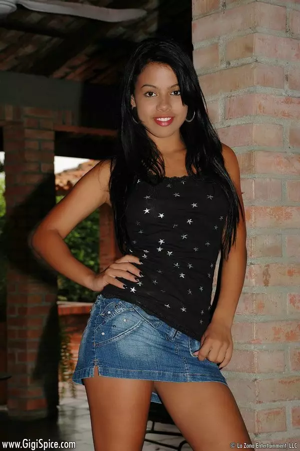 Petite latina Gigi Spice in short jean skirt flashes her small tits and puts her lips on love stick
