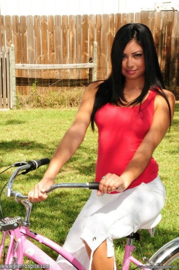 Dishy latina girl Cierra Spice does striptease on a bicycle in the backyard