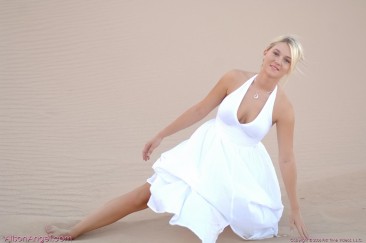 Busty girl Alison Angel in white dress gets nude in the middle of the desert