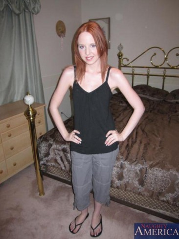Petite redhead Megan Murray strips showing her tiny tits and fingering her slit