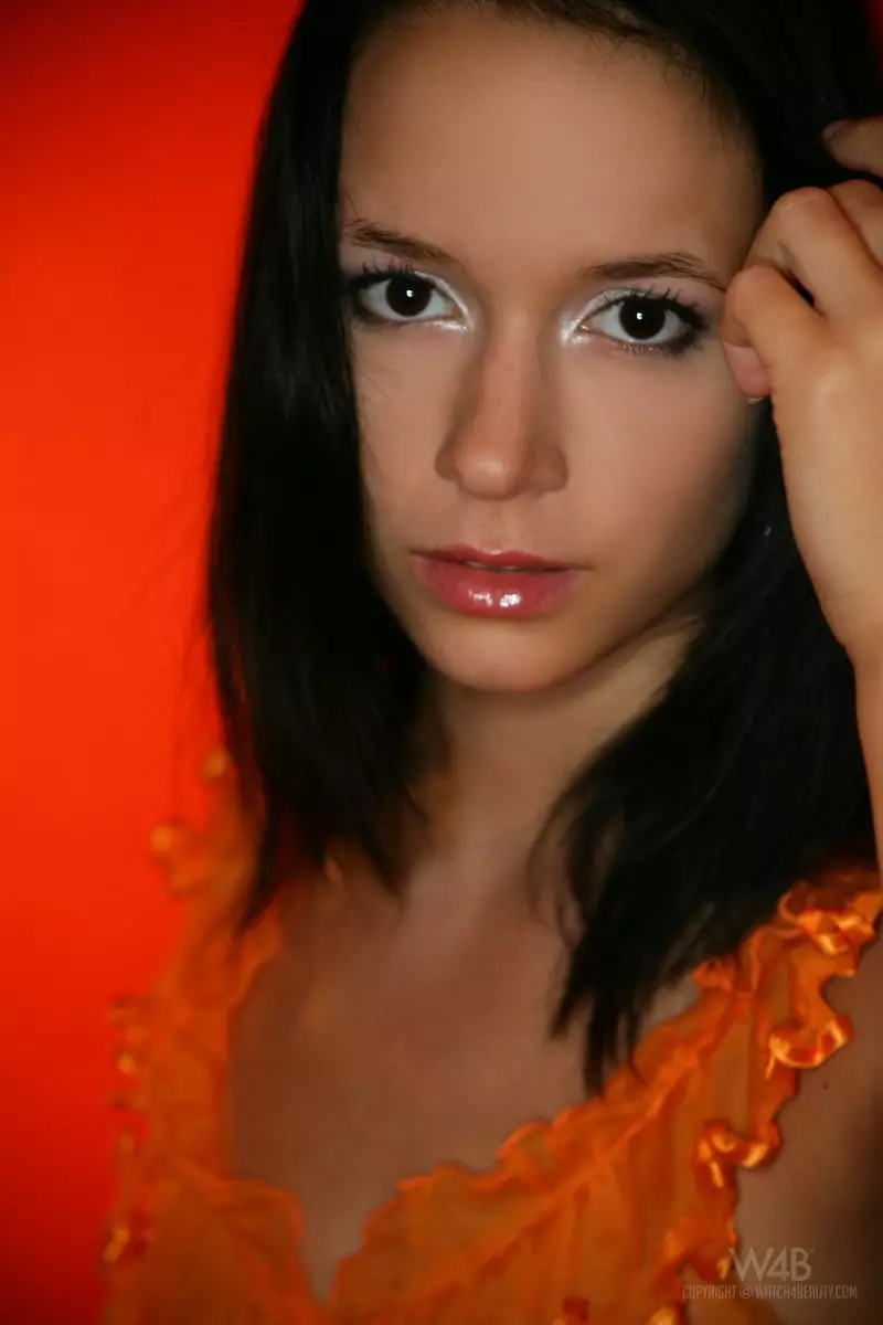 Cute slim brunette model Gwen A strips out of her transparent orange dress