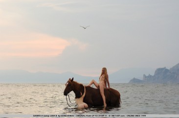 Naked slender lesbian friends Dariya A and Lera B ride the horse naked together at the seaside