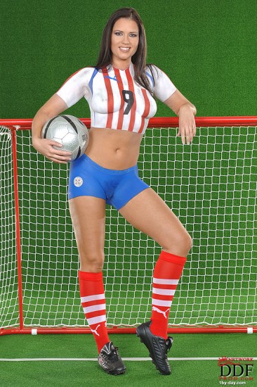 European babe Veronica da Souza in painted soccer uniform poses with a ball
