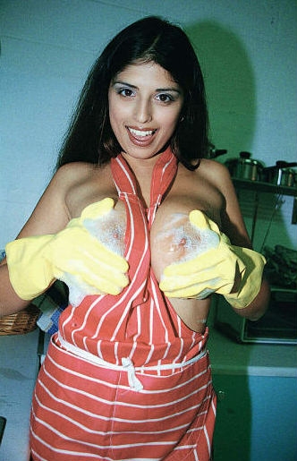 Naughty housewife Kerry Marie in yellow gloves demonstrates her huge jugs and twat