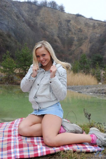 Sassy Nubiles in blue mini skirt takes off her thong and exposes her snatch outdoors