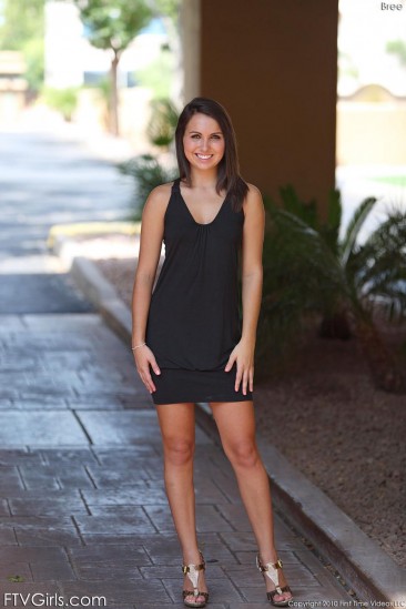 Smiling brunette Bree FTV peels off her black dress and pink panties outdoors